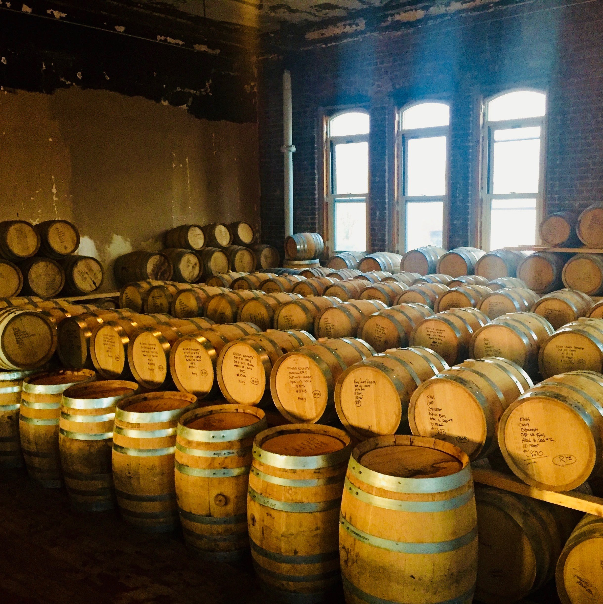 A distillery room filled with barrels