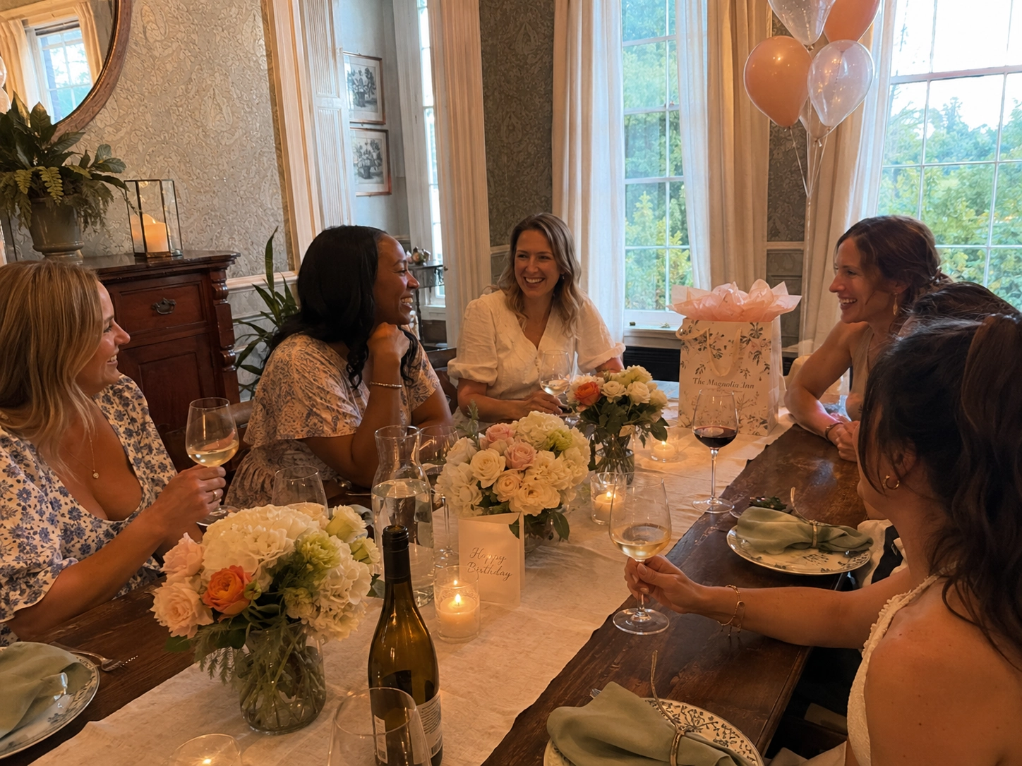 Three women joyfully toast with wine glasses at a candlelit dinner. The atmosphere is warm and lively, conveying a sense of celebration and friendship.